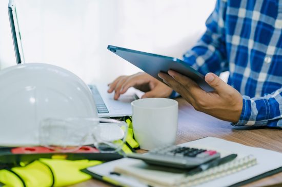 Close-up,Of,An,Architect,Or,Engineer's,Hand,Holding,A,Tablet